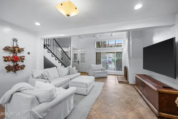 a living room with furniture and a flat screen tv