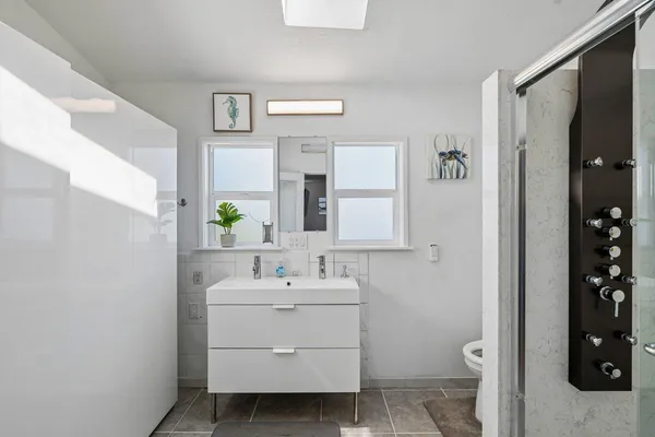 a bathroom with a sink toilet and shower
