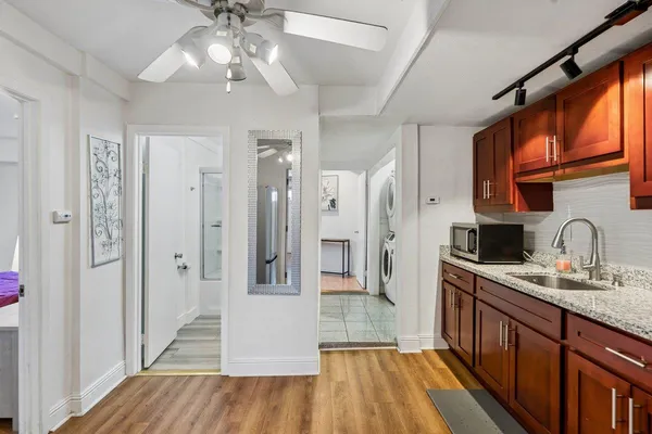 a kitchen with stainless steel appliances a refrigerator sink and cabinets
