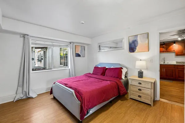 a bedroom with a bed and a tv on the dresser