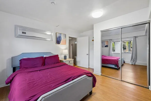 a bedroom with a bed and a walk in closet