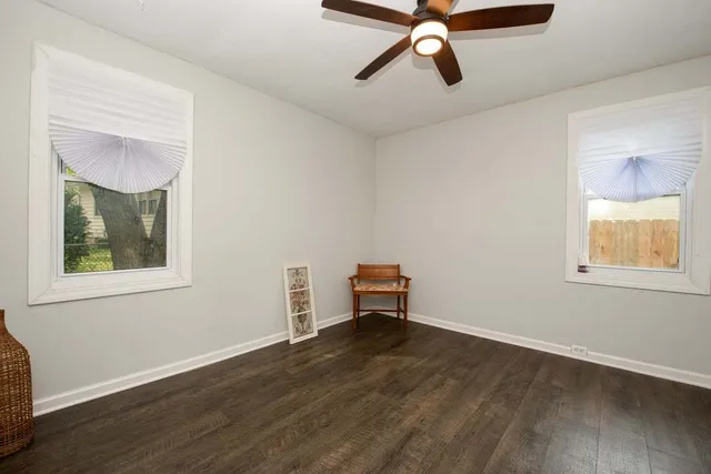 a view of a room with wooden floor and windows