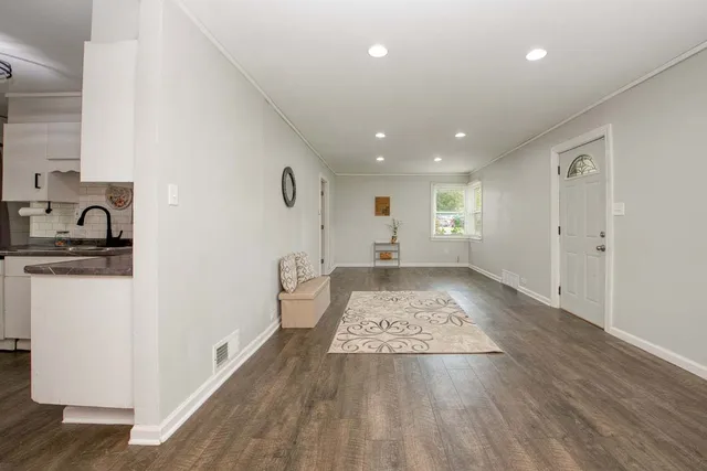 a view of kitchen with a sink and wooden floor