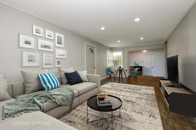 a living room with furniture a rug and a flat screen tv
