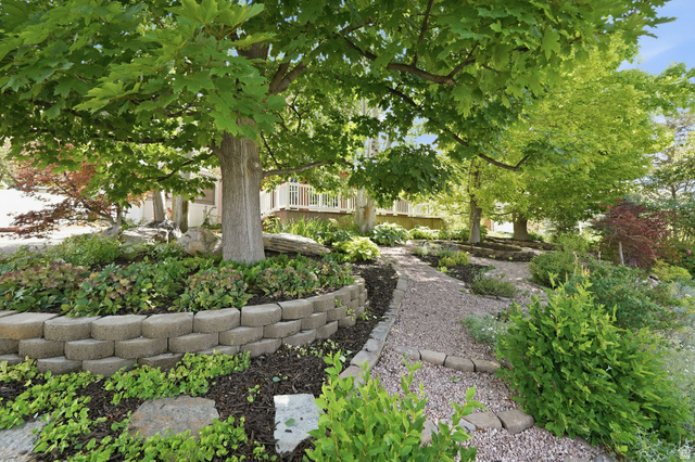 3120 North Apache Way Provo, UT 84604 - Photo 10 of 58 Landscaped front yard featuring mature trees and a gravel pathway