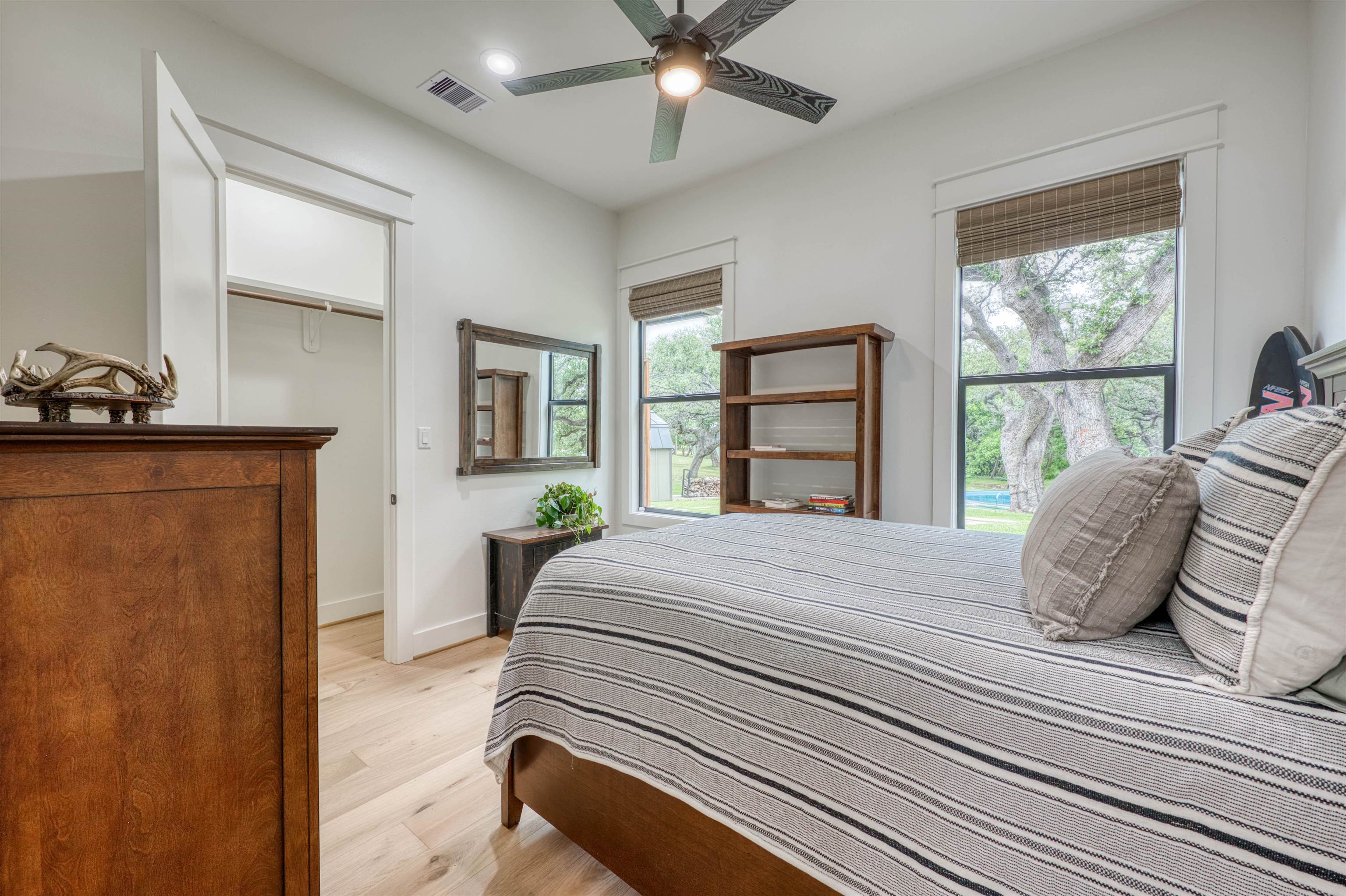 2001 Granite Cove Road Kingsland, TX 78639 - Photo 22 of 42 a bedroom with a large bed and a large window