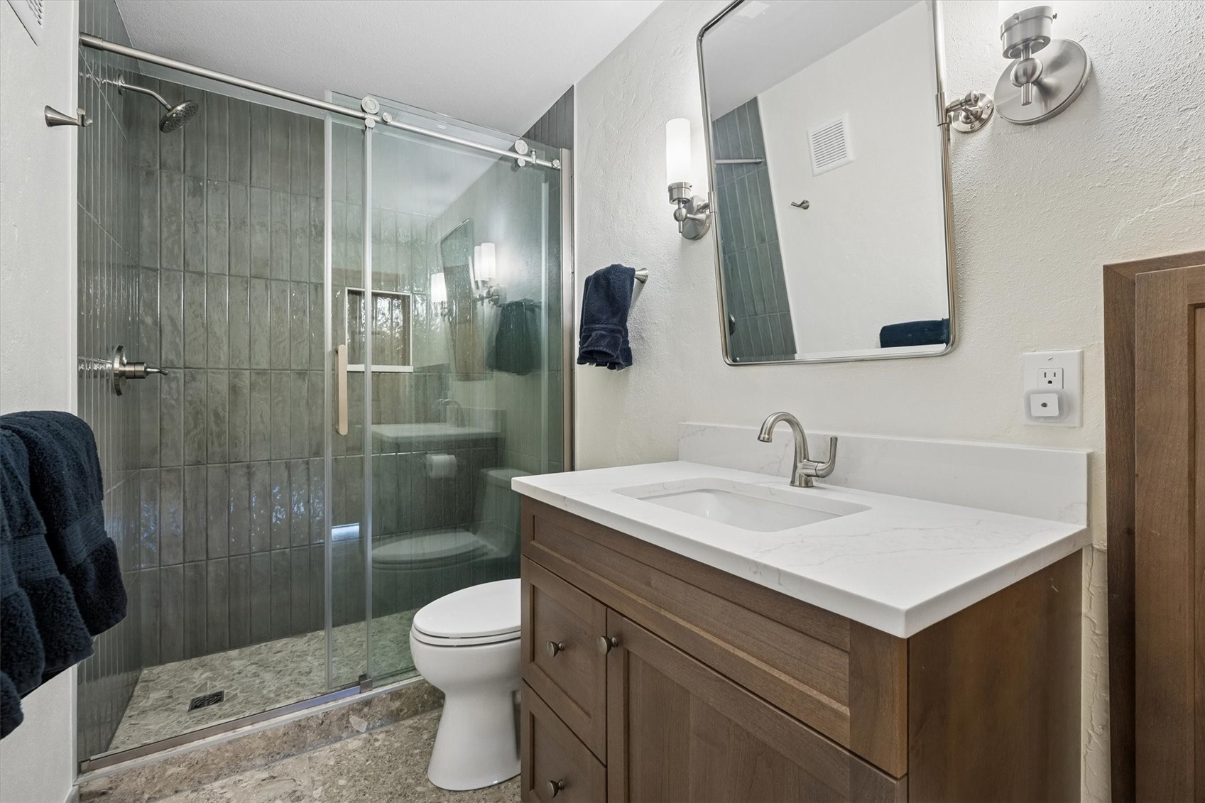 51 West Ranch Trail Morrison, CO 80465 - Photo 44 of 50 a bathroom with a sink toilet a mirror and shower