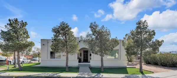a view of a house with a yard and tree s