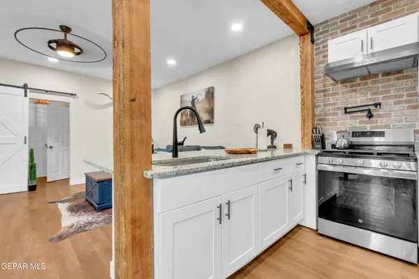 a kitchen with sink cabinets and stove