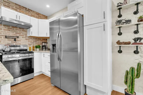 a kitchen with a refrigerator and a stove
