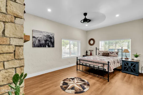 a spacious bedroom with a large bed and a wooden floor