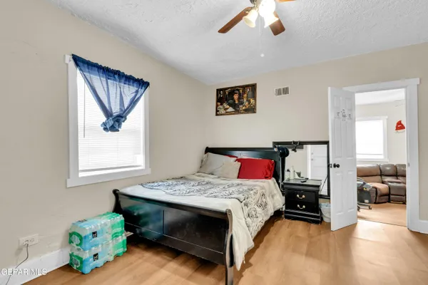 a bedroom with a bed and a chandelier