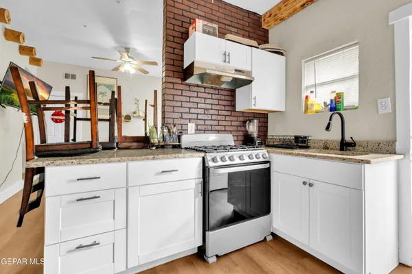 a kitchen with stainless steel appliances white cabinets and a sink