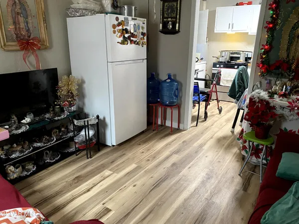 a view of a kitchen with fridge and workspace