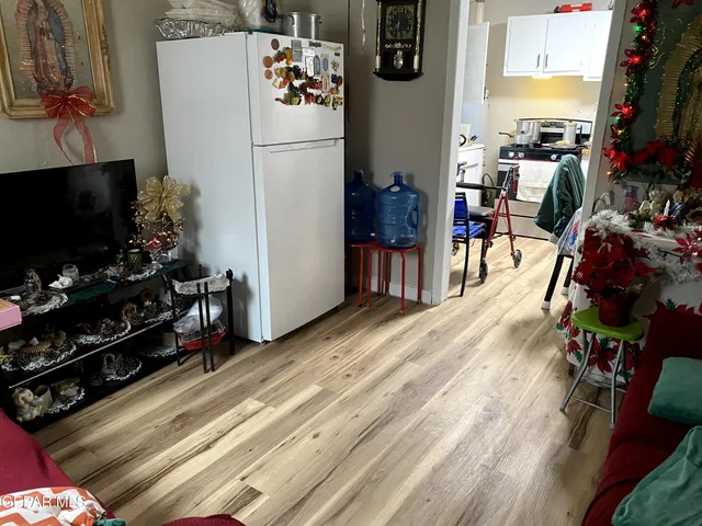 a view of a kitchen with fridge and workspace