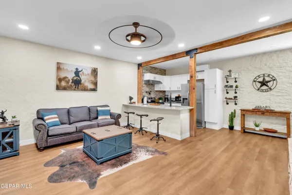 a living room with furniture and kitchen view