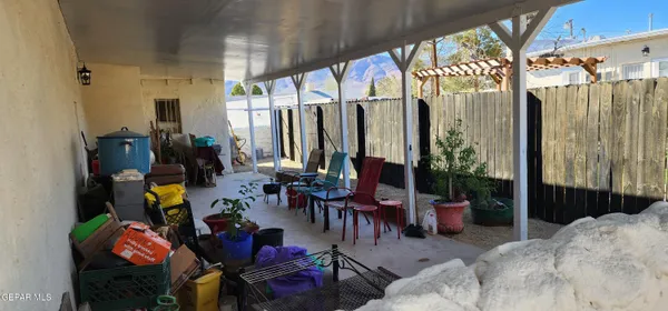 a view of a patio with table and chairs potted plants with wooden floor