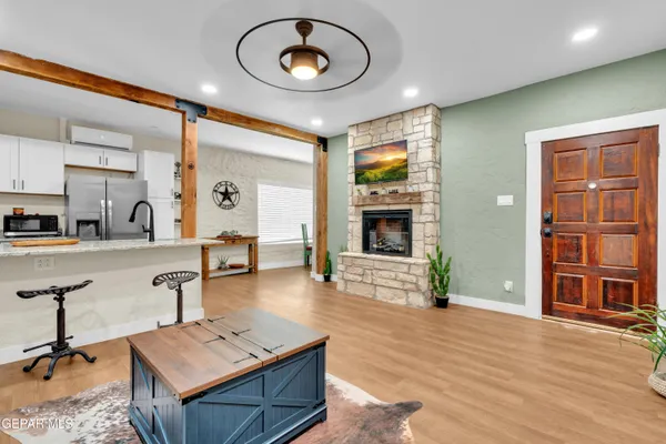 a living room with furniture a flat screen tv and a fireplace