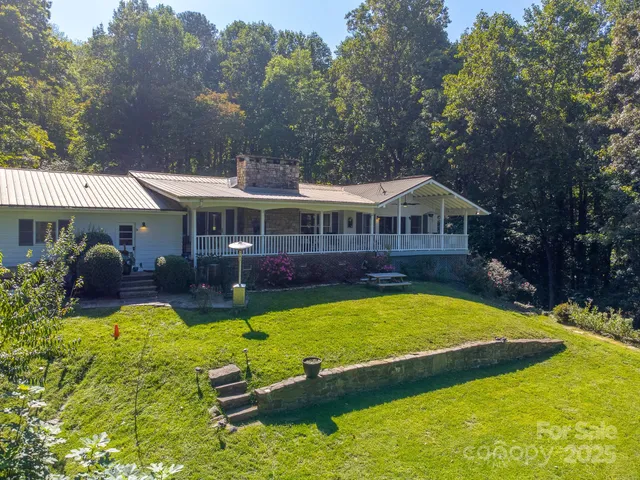 a view of a house with swimming pool and porch