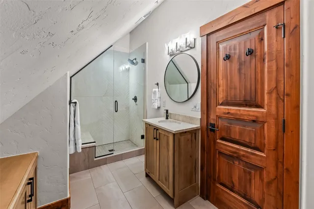 a bathroom with a sink a mirror and a shower