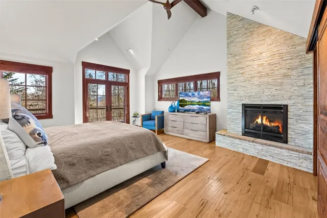 a spacious bedroom with a bed and a fireplace