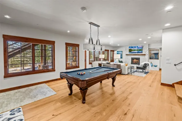 a living room with furniture a rug and a large window