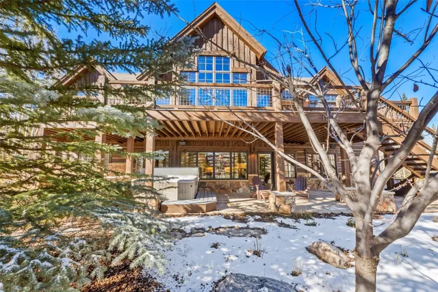 a view of residential houses with yard and wooden fence