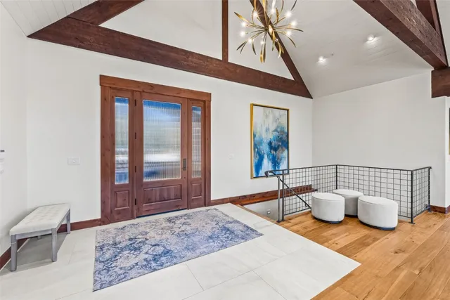 a living room with fireplace furniture and a large window