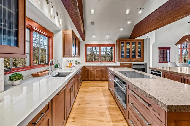 a kitchen with stainless steel appliances granite countertop lots of counter top space and wooden floor