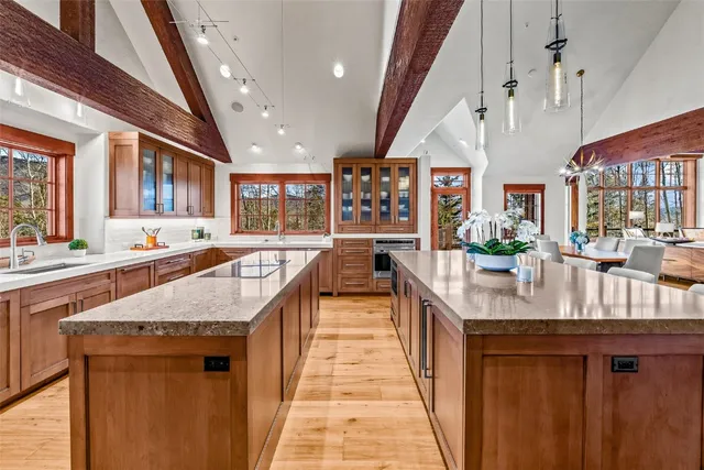 a kitchen with stainless steel appliances granite countertop lots of counter top space and wooden floor