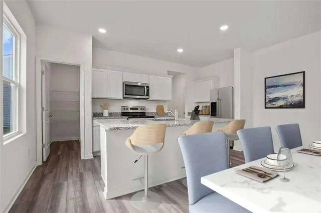 an aerial view of a house with a garden and lake view