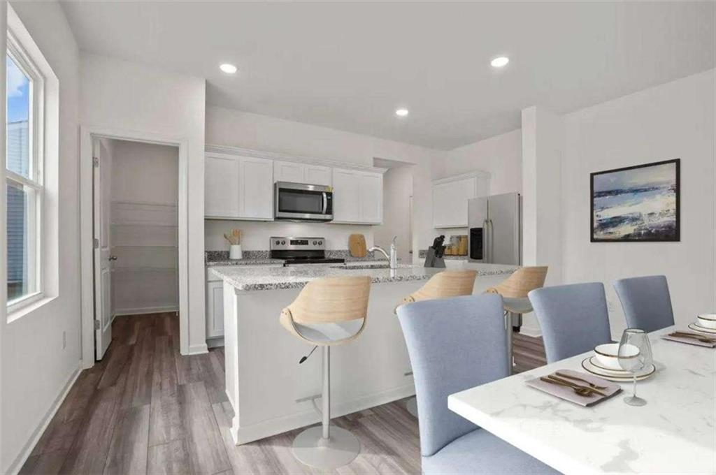 494 Otway Loop Winder, GA 30680 - Photo 8 of 17 a kitchen with a table chairs refrigerator and microwave