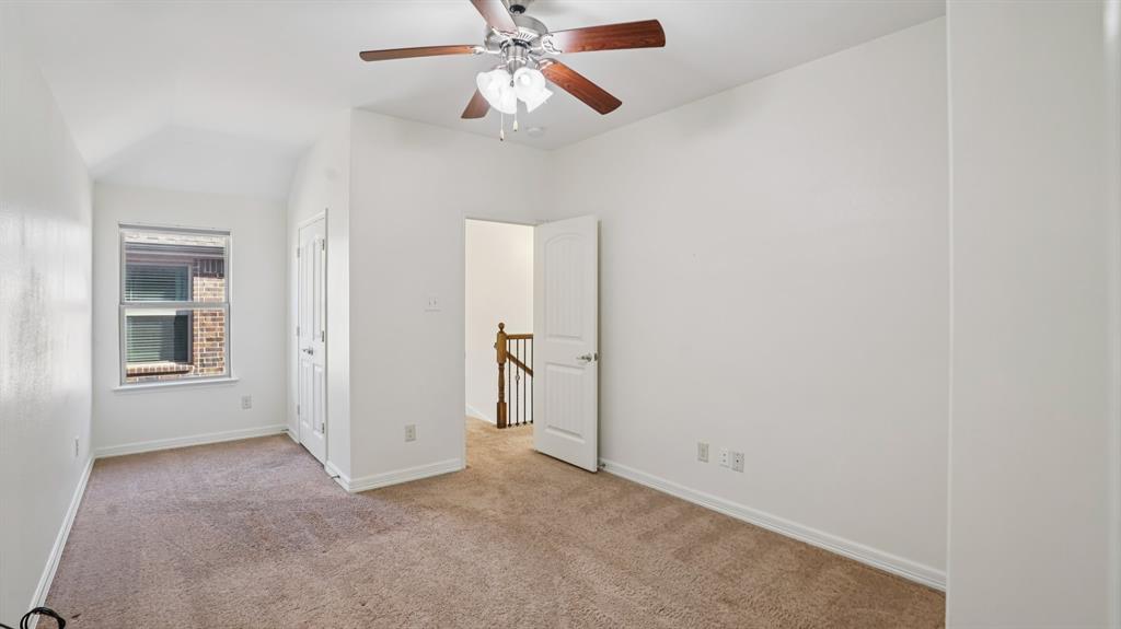 9904 Copperhead Lane McKinney, TX 75071 - Photo 28 of 40 Unfurnished bedroom with light colored carpet, vaulted ceiling, and a ceiling fan