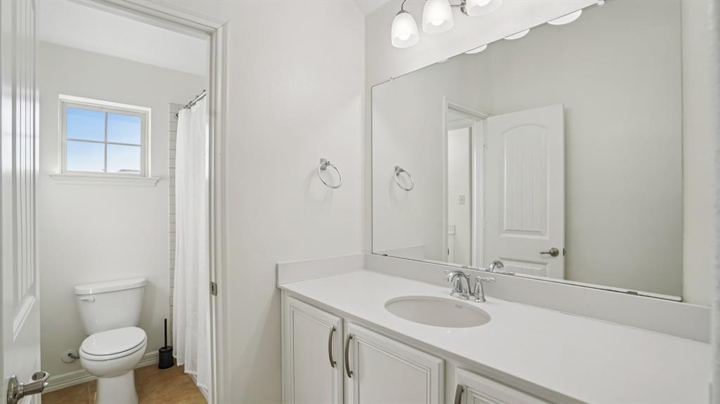 9904 Copperhead Lane McKinney, TX 75071 - Photo 32 of 40 Bathroom featuring a shower with shower curtain and vanity