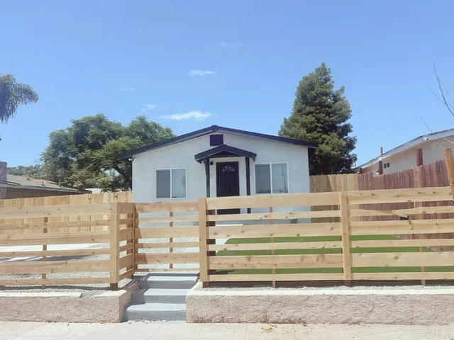 a view of house with wooden fence