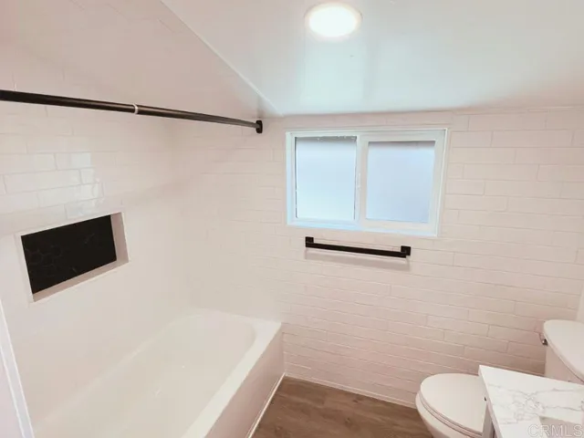 a bathroom with a toilet a sink and a shower