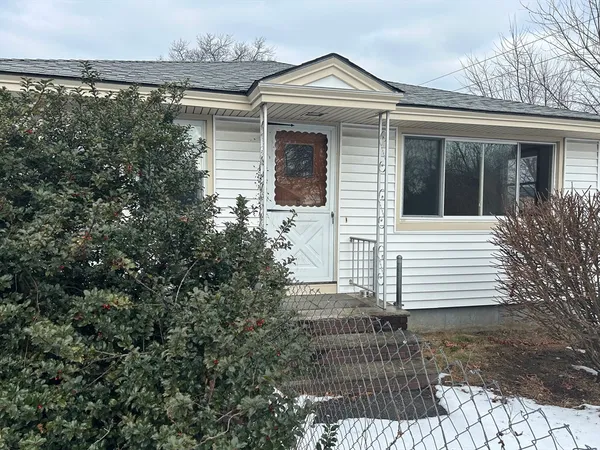 a view of house with backyard and sitting area