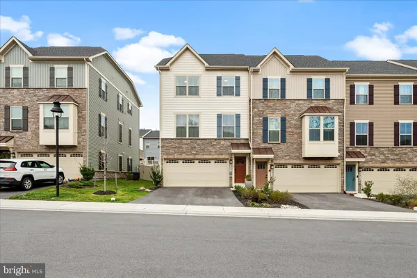 a front view of a residential apartment building with a yard