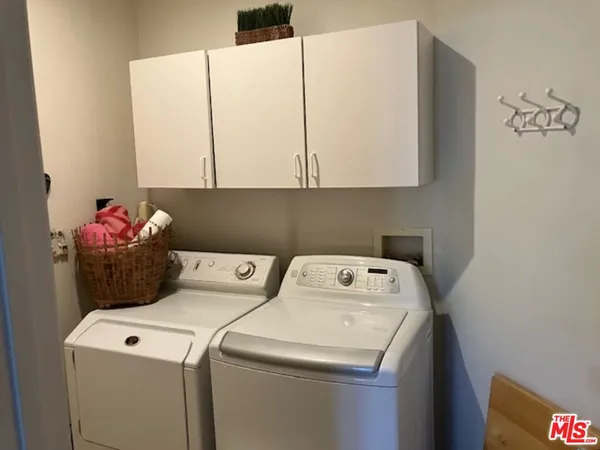 a bed room with furniture and a flat screen tv