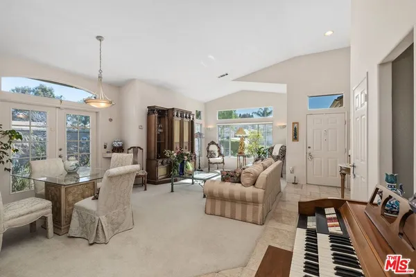 a living room with furniture potted plant and a chandelier
