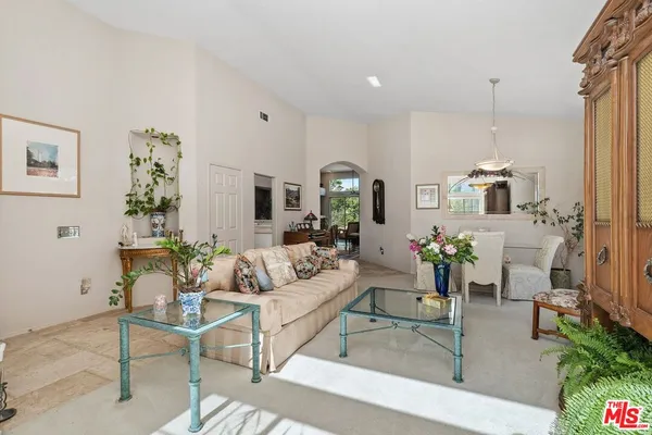 a living room with furniture a window and a flat screen tv