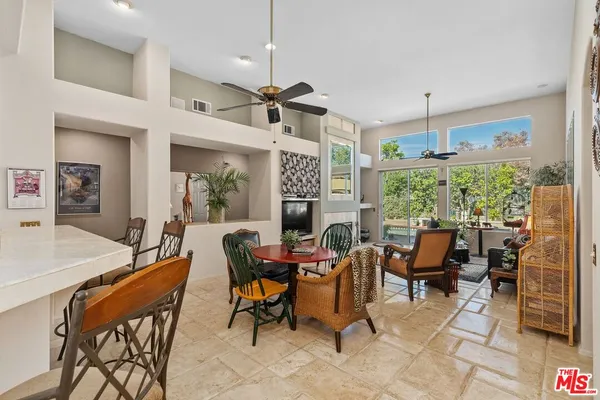 a kitchen with stainless steel appliances kitchen island granite countertop a refrigerator and microwave