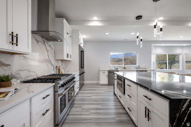 476 Spring Drive Toquerville, UT 84774 - Photo 16 of 95 Kitchen featuring dark stone countertops, premium appliances, white cabinetry, and decorative light fixtures