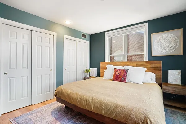 a bedroom with a large bed and a window