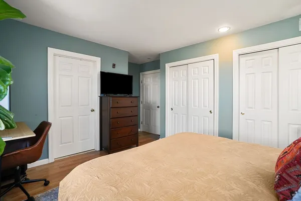 a bedroom with a bed and a flat screen tv