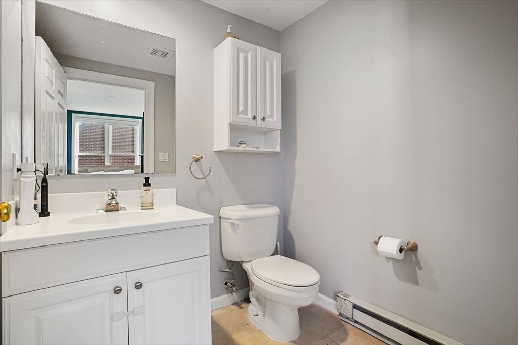 65 Chelsea Street, Unit 305 Boston, MA 02129 - Photo 17 of 30 a bathroom with a toilet a sink and mirror