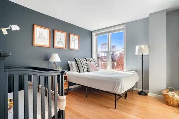 a bedroom with a bed and wooden floor