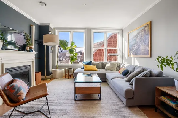 a living room with furniture fireplace and window