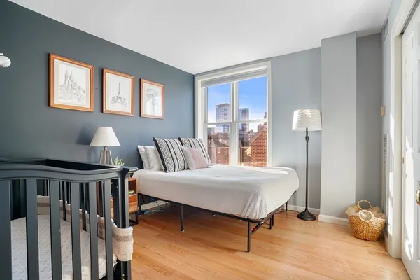 a bedroom with furniture and a window