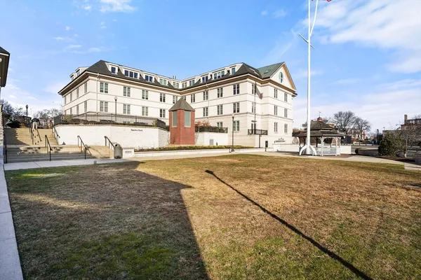 a view of a big building next to a yard